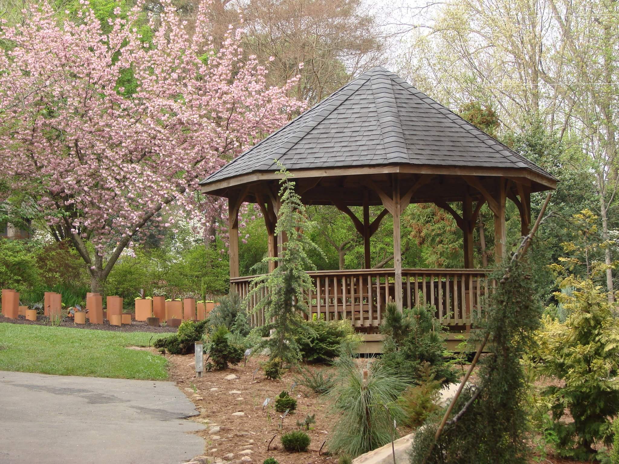 A wooden gazebo in a garden