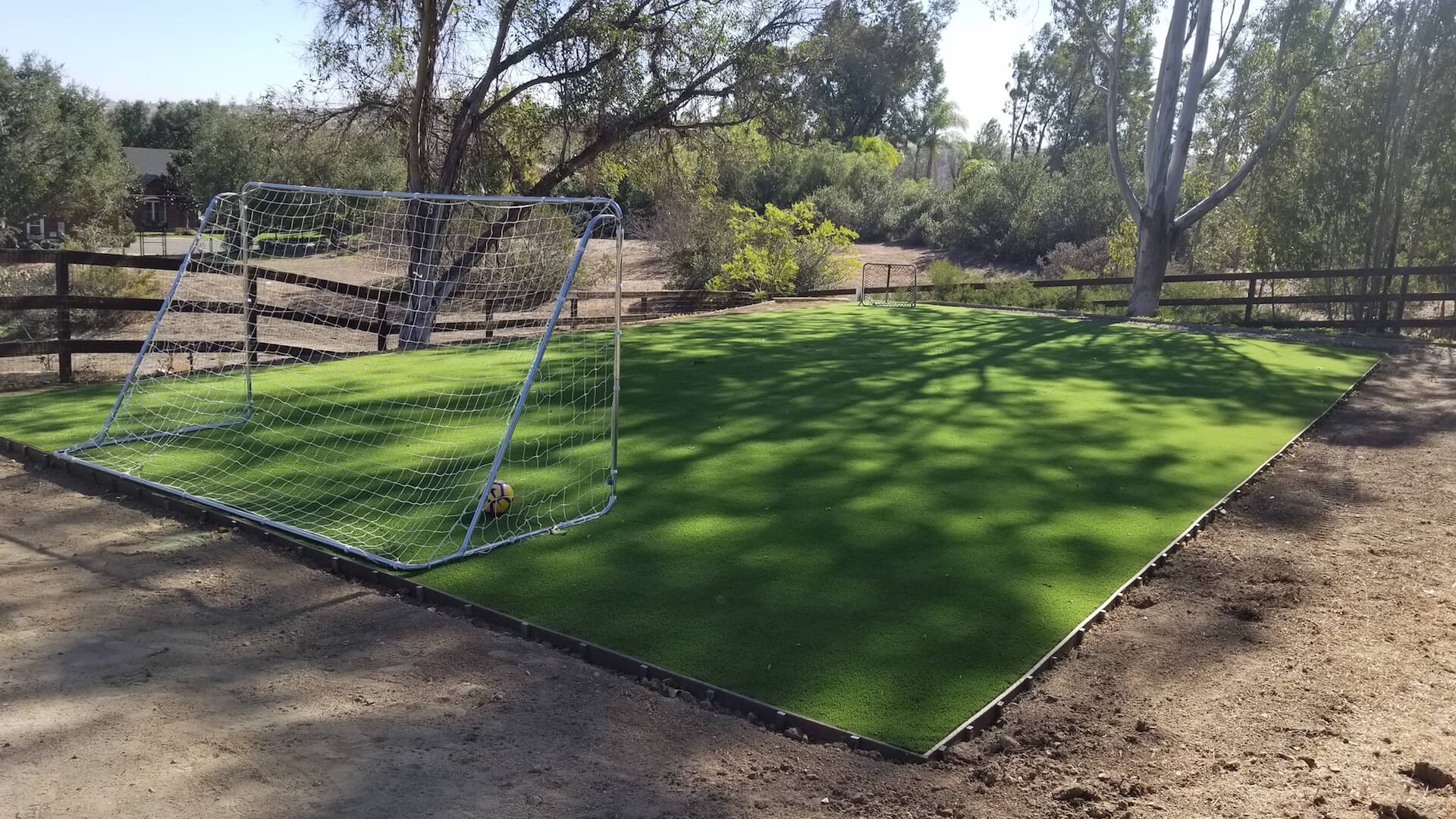 A backyard soccer field with artificial turf