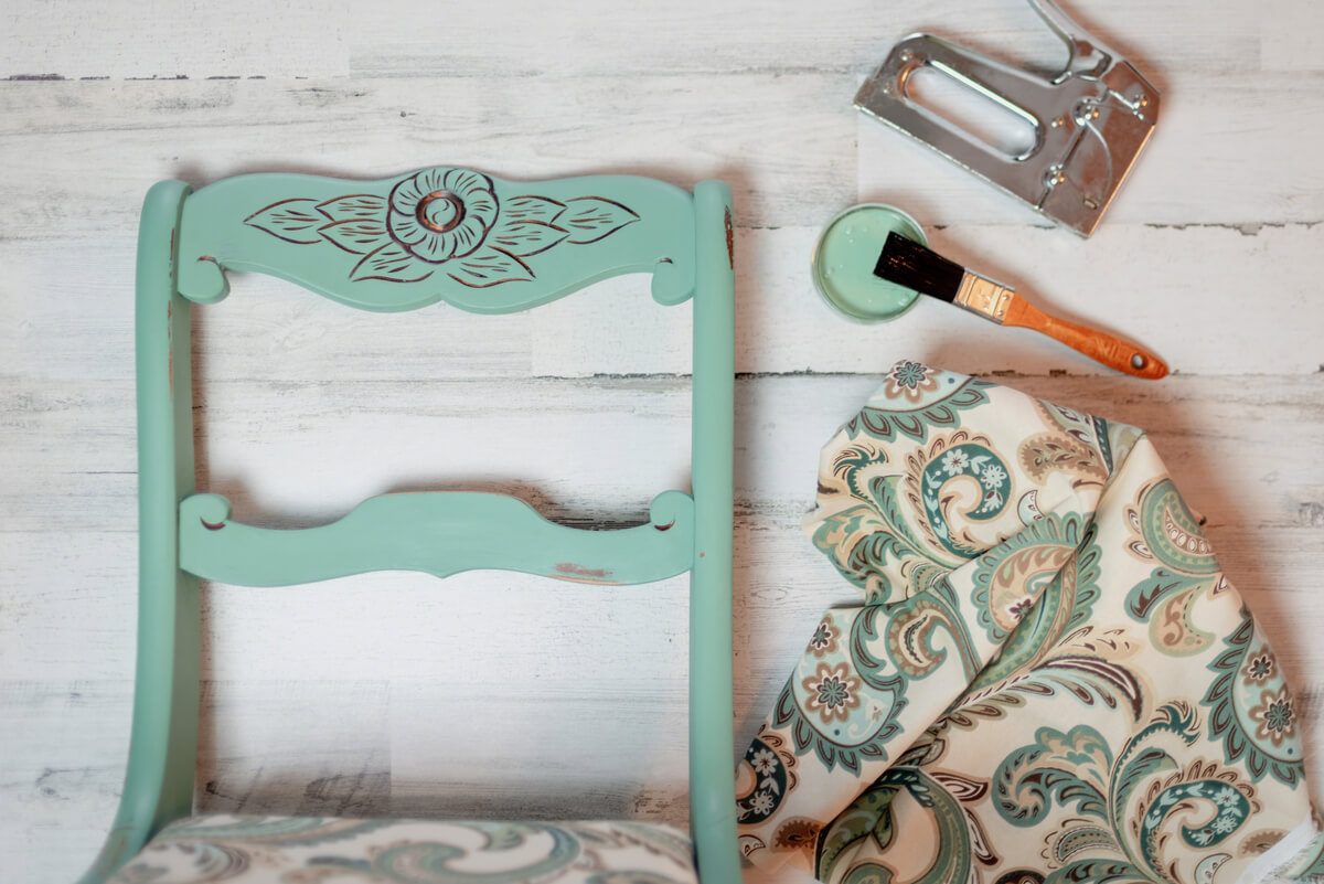 A chair being reupholstered with patterned fabric